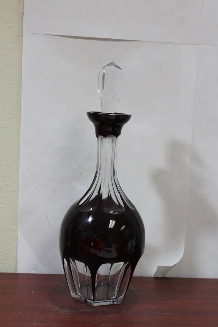 A Ruby Red Facet Cut Glass Decanter: please note: lip chip and a couple of flea bites - 13 3/4" tall