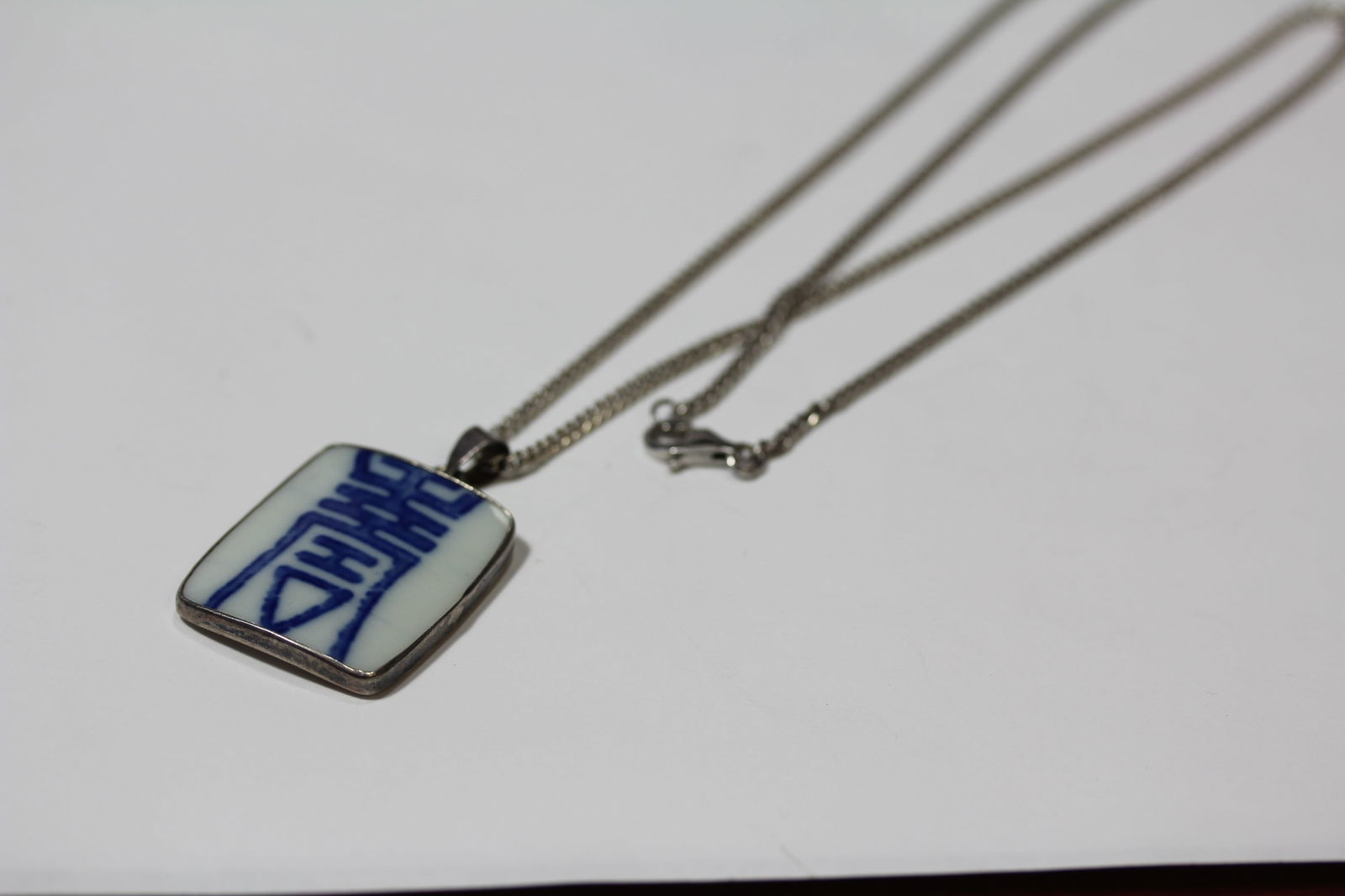 A Chinese Sterling Necklace with Porcelain Pendant: Porcelain Symbol Pendant -14" long when clasped