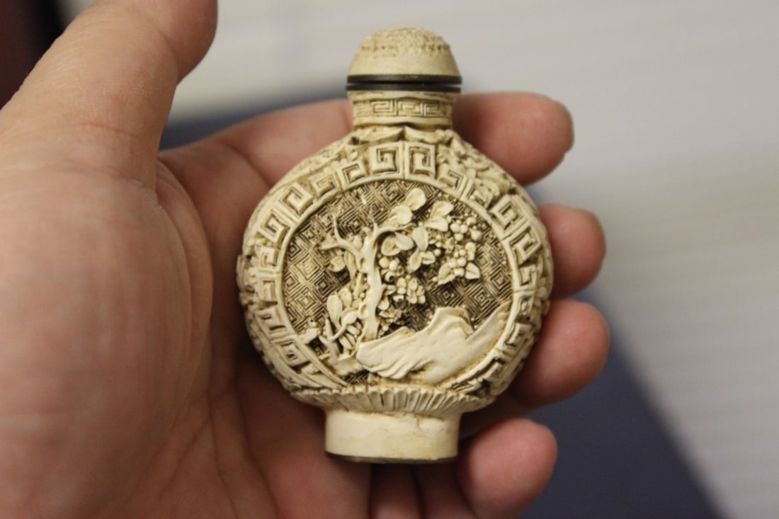 A Chinese Cinnabar Snuff Bottle: signed on the bottom - 2 3/4" tall