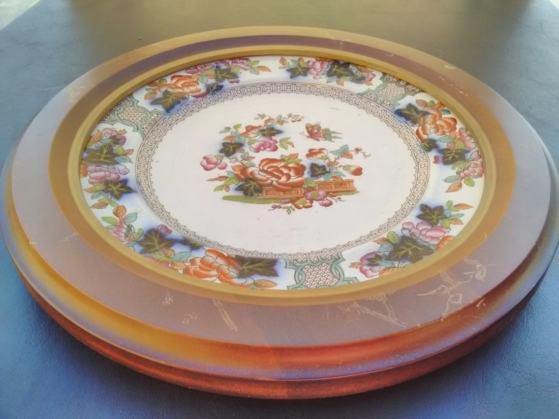 An Antique Flow Blue Ironstone Pottery Plate: Mounted in a wooden round frame - Overall= 13 1/2 inches in diameter - 19th century
