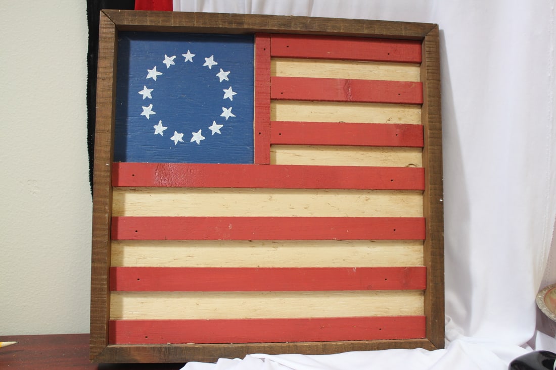 A Wooden Flag Wall Hanger: 17" x 17 1/4"