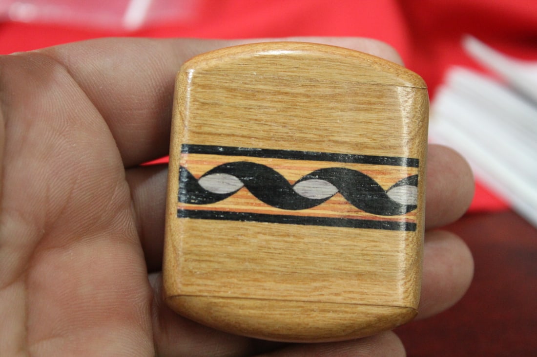An Inlaid Wooden Slide Trinket Box: 2" across