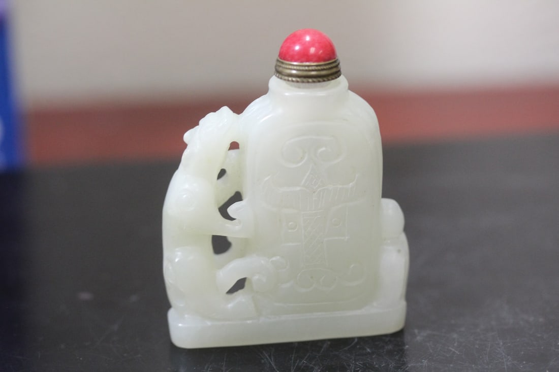 A Chinese White Jade Snuff Bottle: carved - 2 3/8" tall