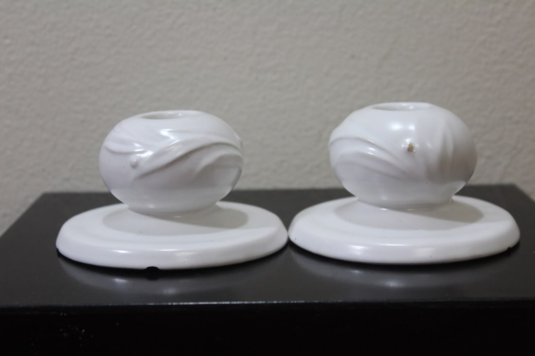 A Set of Two Pottery Candlesticks: please note: both have underchips as shown - 4" in diameter