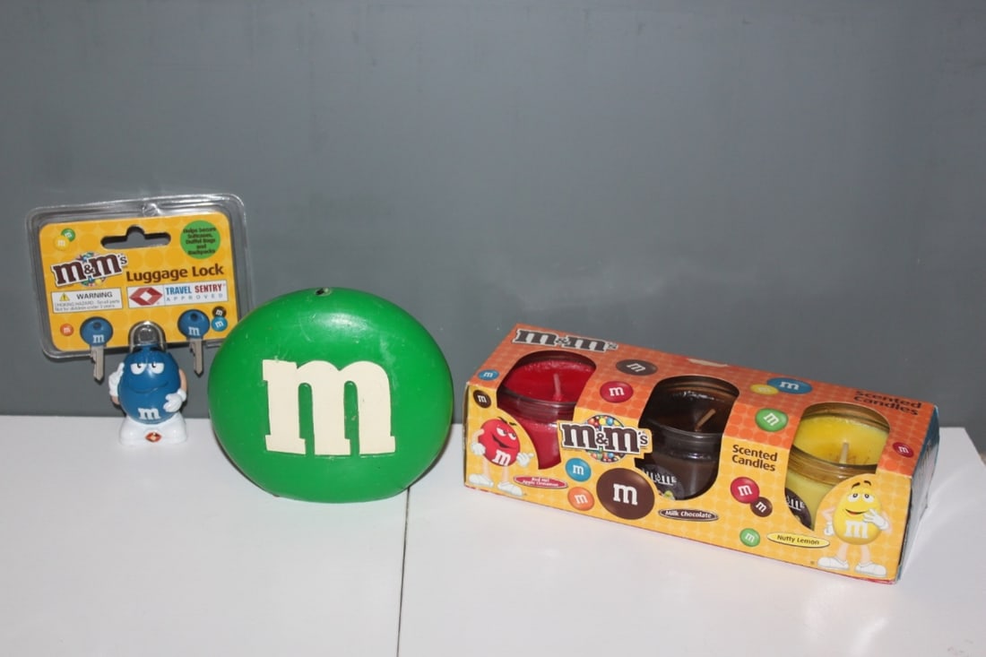 Lot of 3 M&M's Articles: Luggage Lock - Blue - NEW, Candles - Scented Candles and Larger Green Candle that is 4 5/8 inches at the widest point