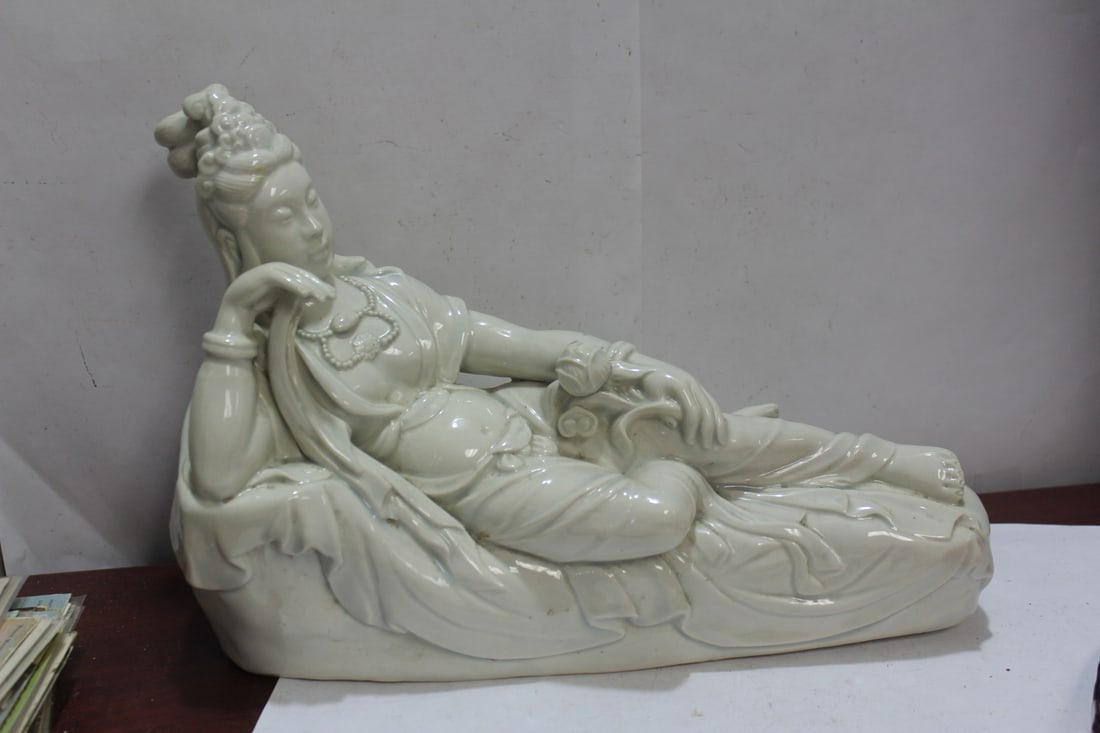 A Reclining Chinese Blanc de Chine Kwan Yin: marked China - 12 inches across