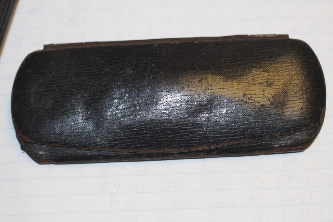 An Antique Metal and Cloth Glass Case: as shown