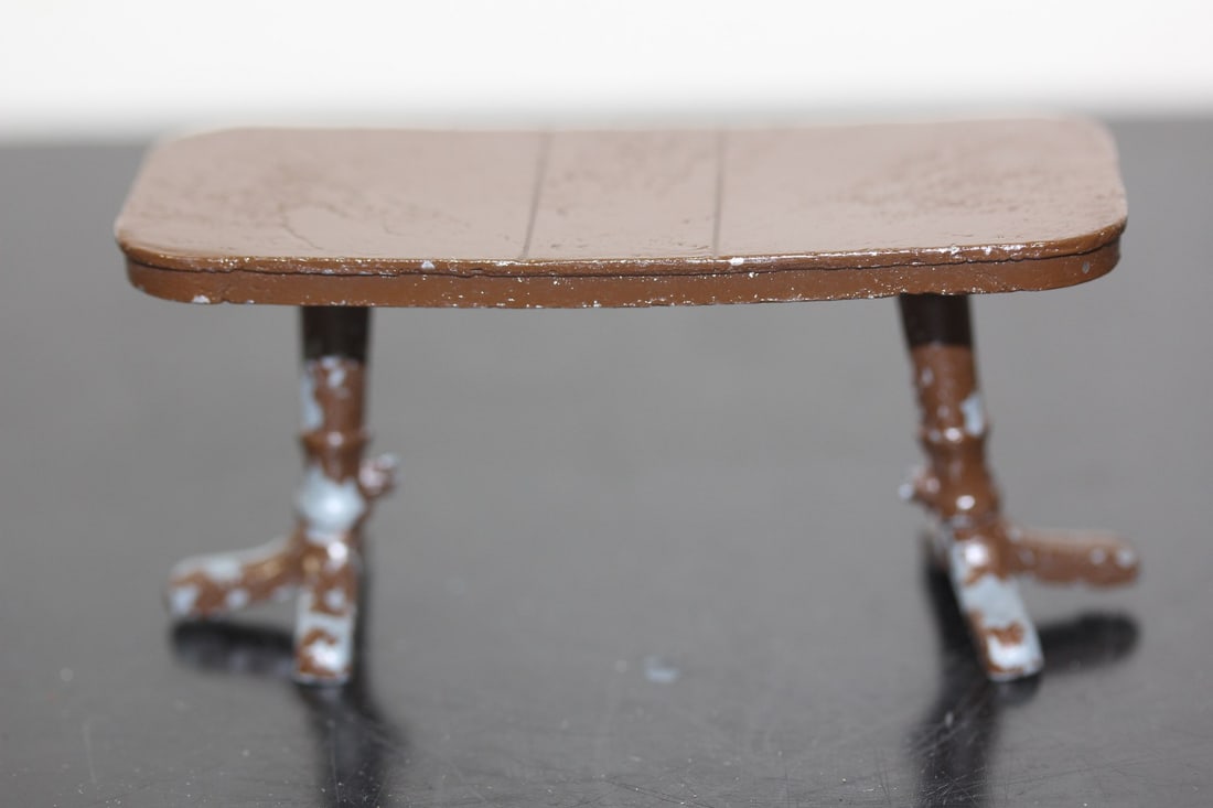 A Rare Vintage Metal Doll House Furniture: a table - please note: suspending bar broke off, but table still stands up - 3 3/8" across
