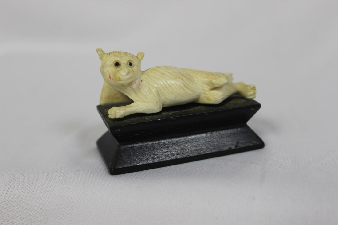 A Carved Monkey: on stand - overall= 2 1/8" across