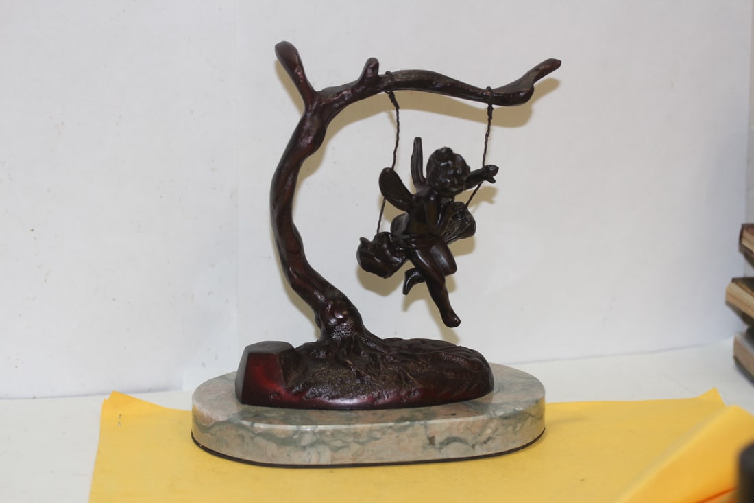 A Swinging Angel Sculpture: 6" across