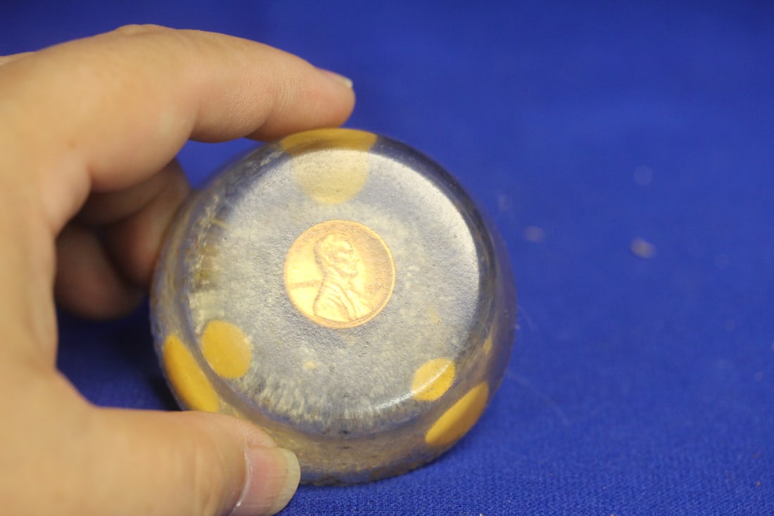 A Lucite and Penny Paperweight: please note: edge roughness - 2 3/8" across