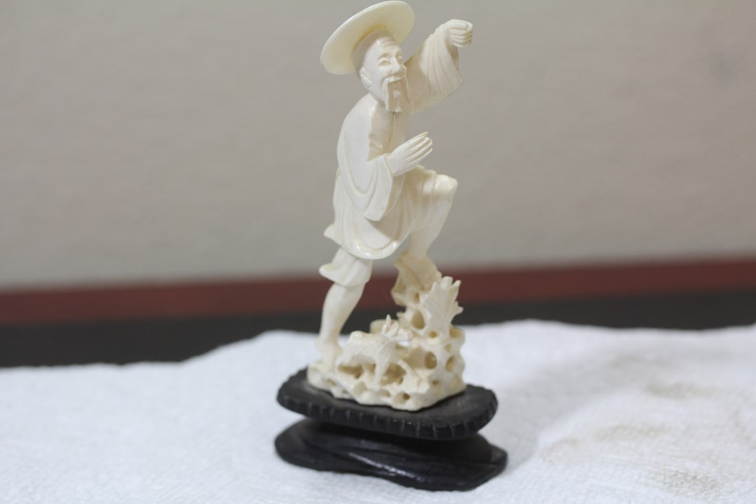 A Chinese Carved Bone Fisherman: please note: missing fishing pole - overall= 5" tall