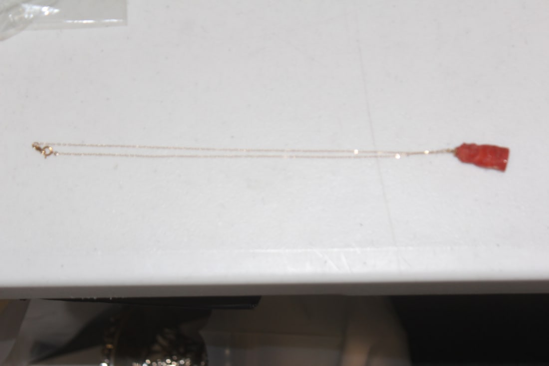 Chinese Carved Coral Pendant on a 14Kt Gold Chain: marked 14karat - overall= 9inches long - pendant= 7/8" long