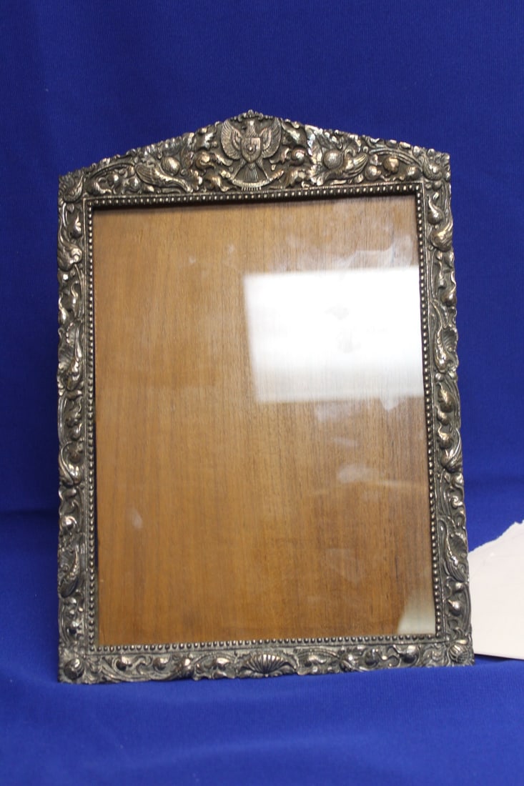 An Antique Sterling Ornate Frame: overall= 12" x 8 1/2" - inside measurement= 6 3/4" x 9" - marked 925