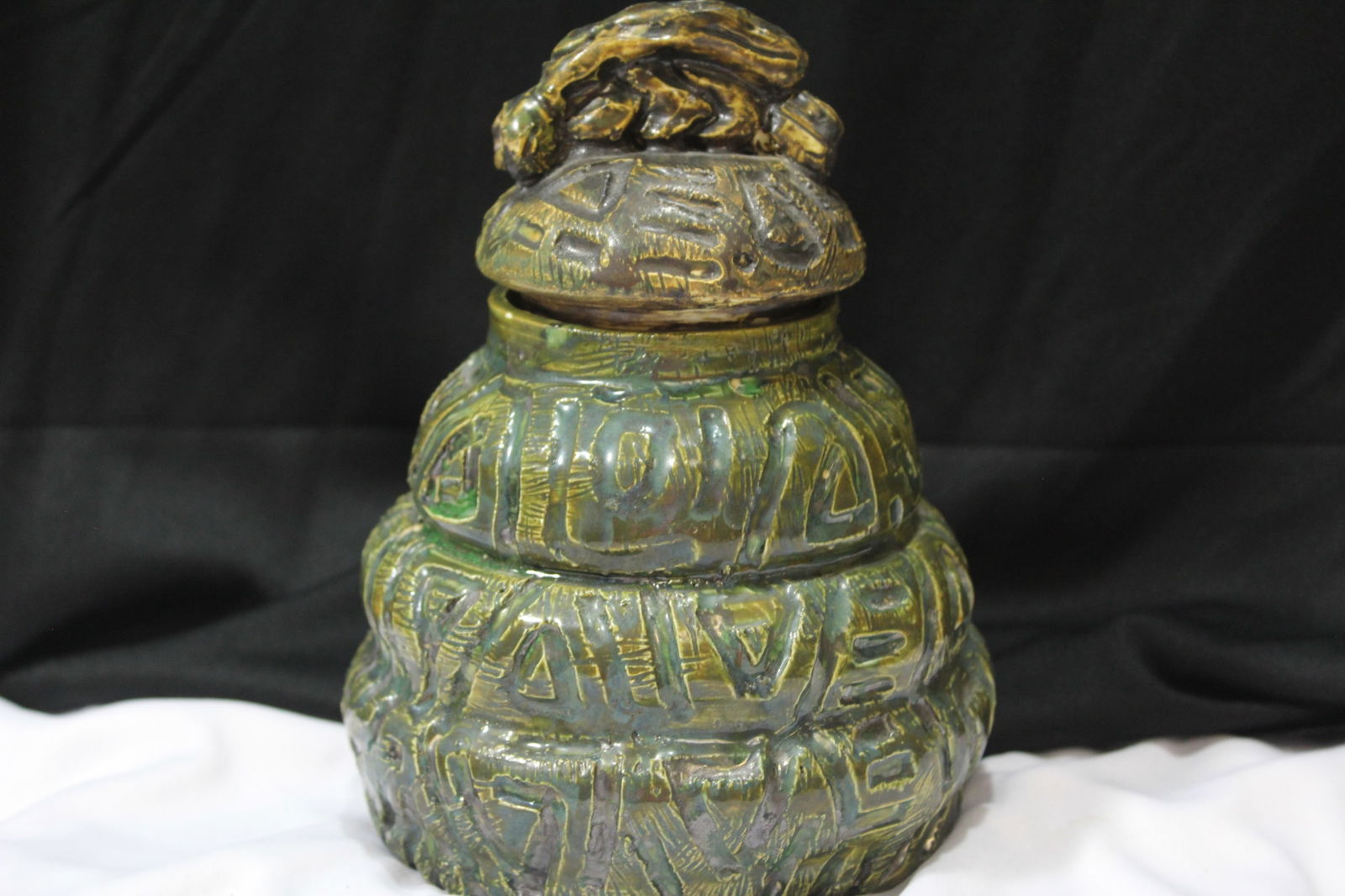 A Pottery Container: please note: one inside chip on the lid, however, well made - has a signature, but do not know what it is - 7 1/2" tall