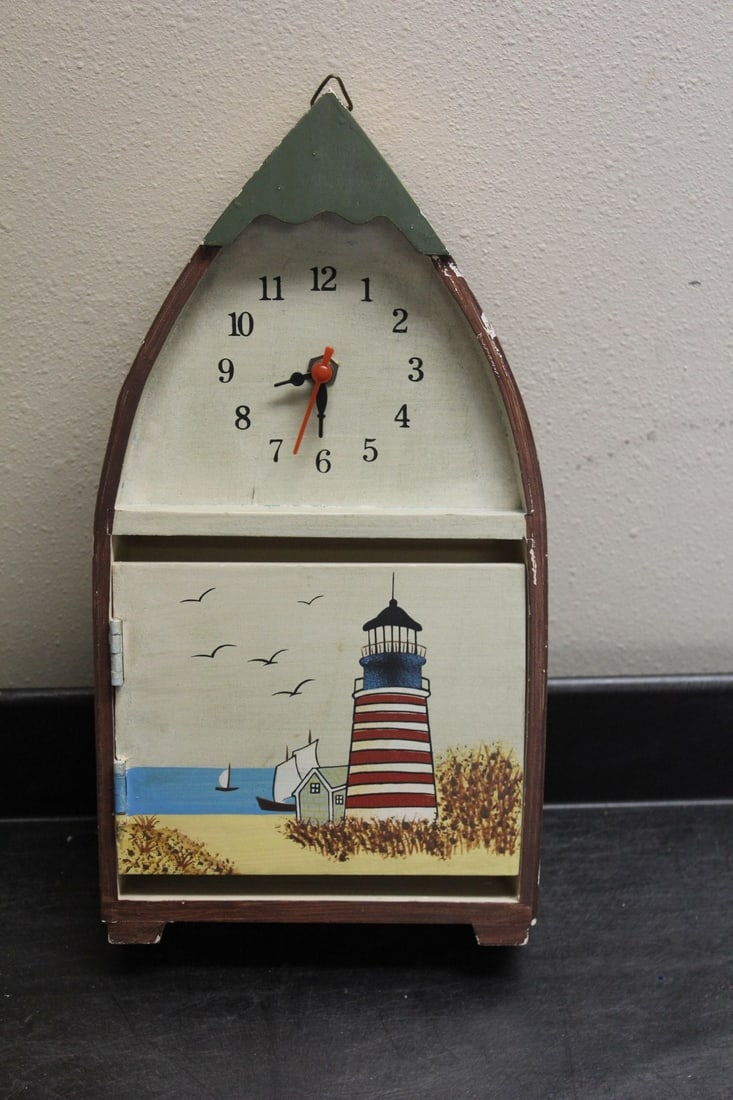 A Light House Clock: currently working, but better to change the battery holder, as the side of the holder is broken - 12 1/4" tall - a wall hanger