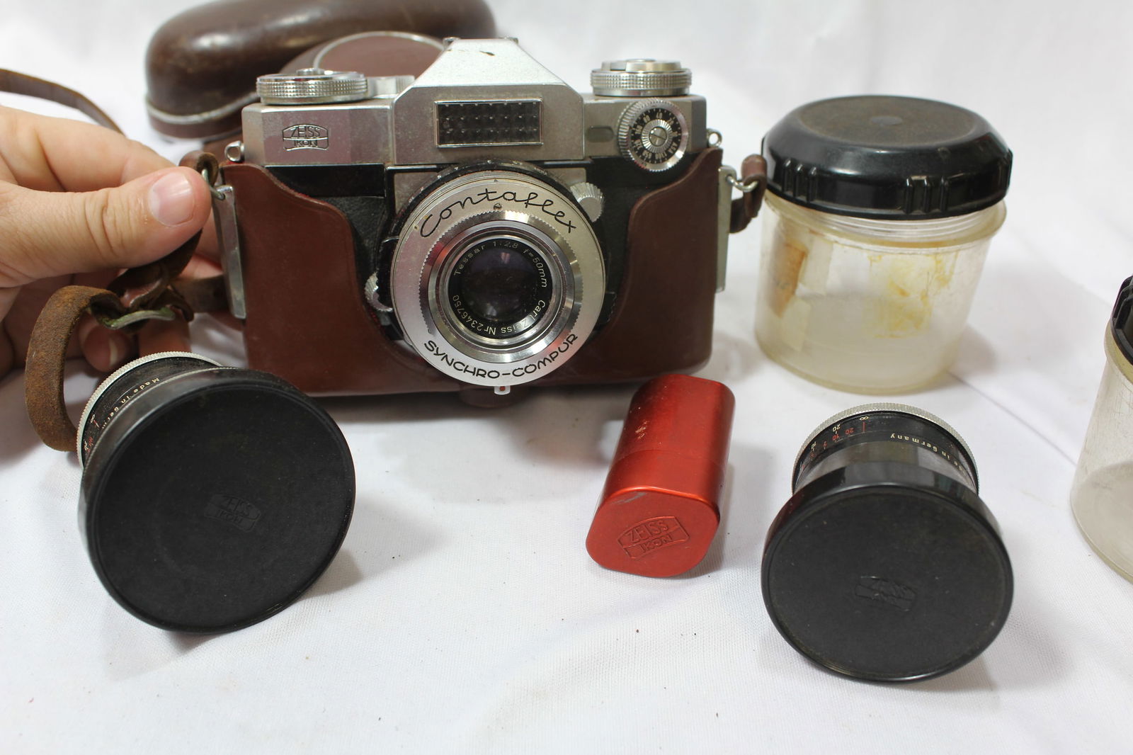 A Contaflex Camera: plus two lenses - do not know if it is fully functioning or not - as found - also to include a Zeiss/Ikon film canister