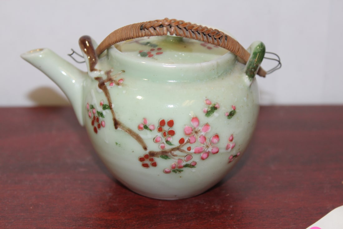 A Chinese or Asian Celadon Small Teapot: Antique/Vintage - with rattan handle - 4" across