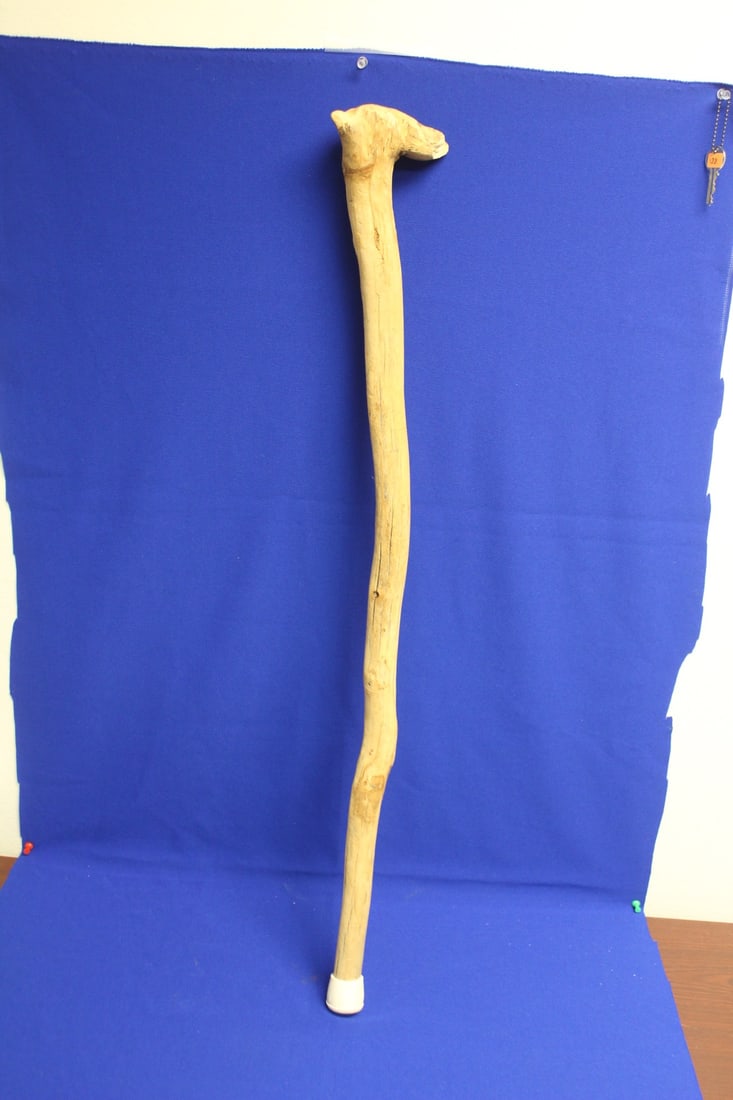 A Natural Wooden Cane: resembles a dog head on top - please note: crack, losses - 34" long 