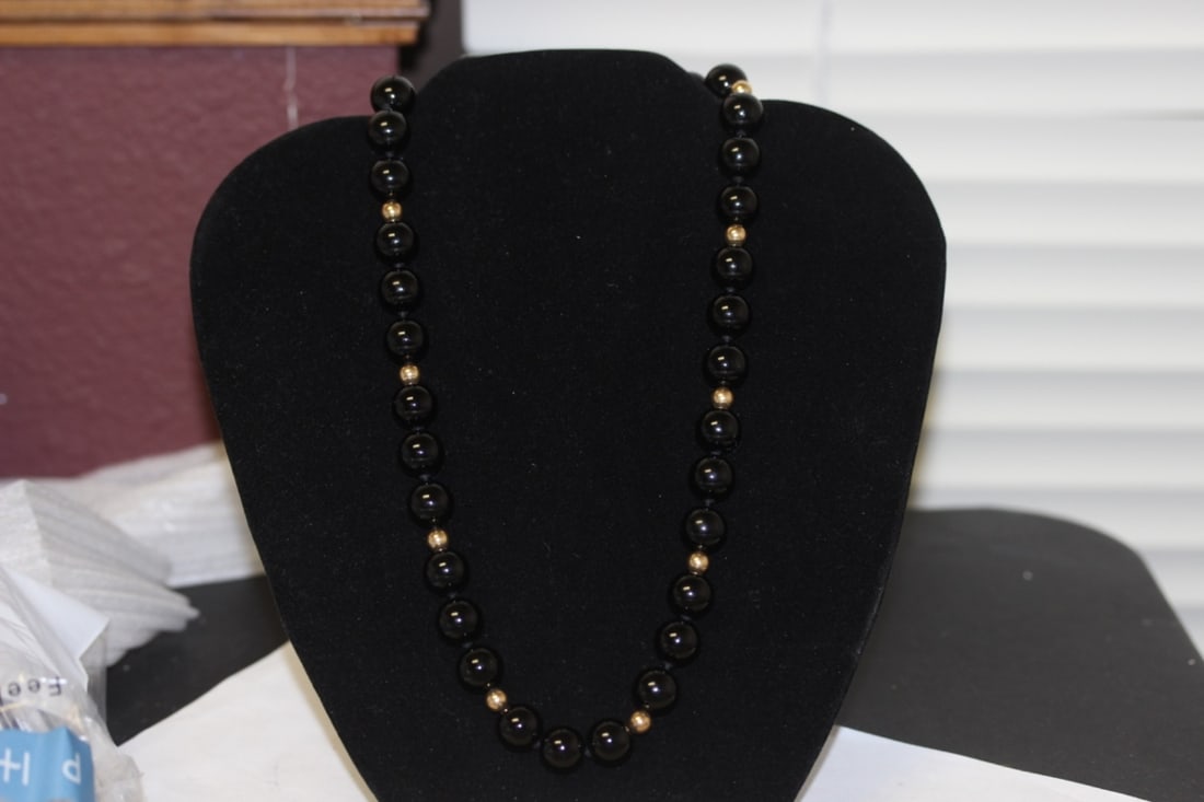 A 14 Kt Gold and Onyx Necklace: 18 1/2" long unclapsed - each bead is about 10mm in diameter - black onyx
