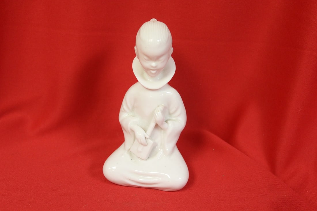 A Blanc de Chine Figurine: please note: broken handle of the music instrument - 5 1/2" tall
