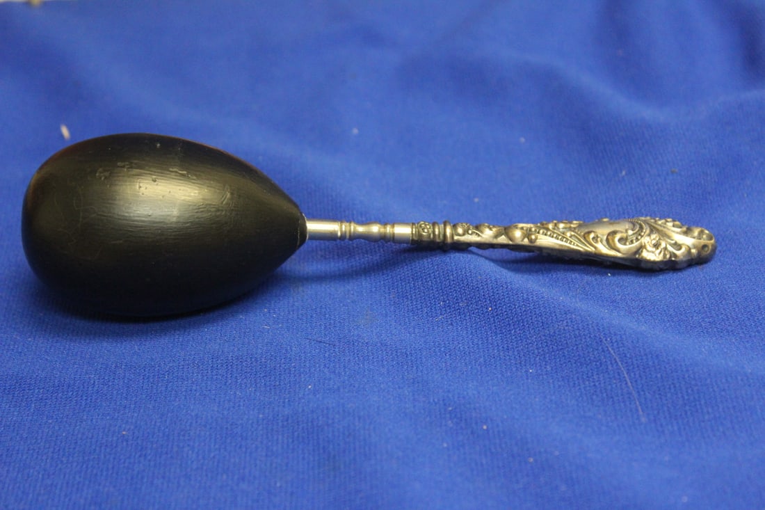 A Sterling Handle Wooden Sock Darner: 7 inches across - ornate