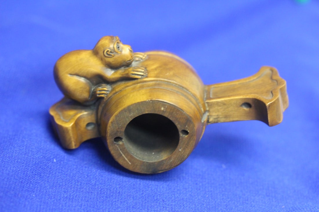 A Well Carved Wooden Monkey on a Barrel: most likely Japanese - 4 inches across