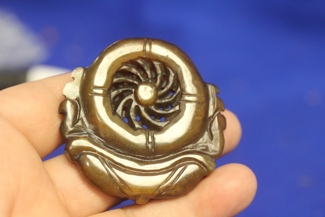 A Hardstone or Jade Pendant: please note: chip as shown - 2 1/8" in diameter