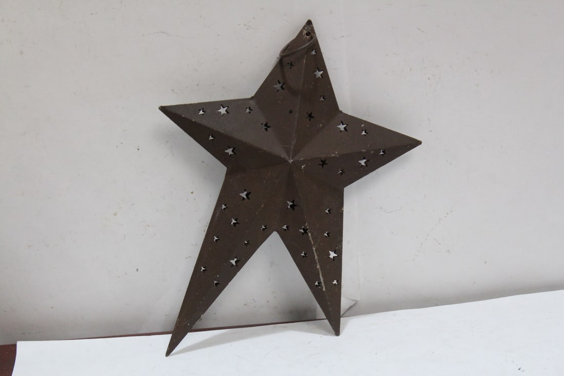 A Hanging Metal Star Ornament: 8" tall