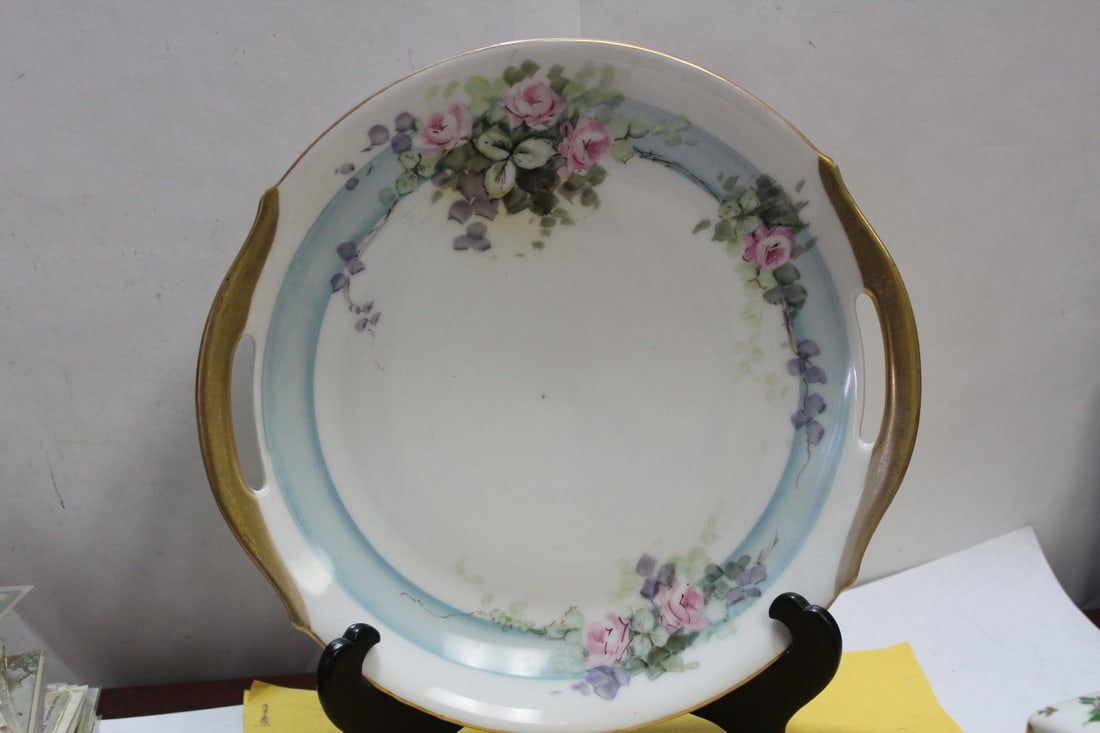 An Antique Rose Plate: with two handles - measures 10 1/4" in diameter from handle to handle