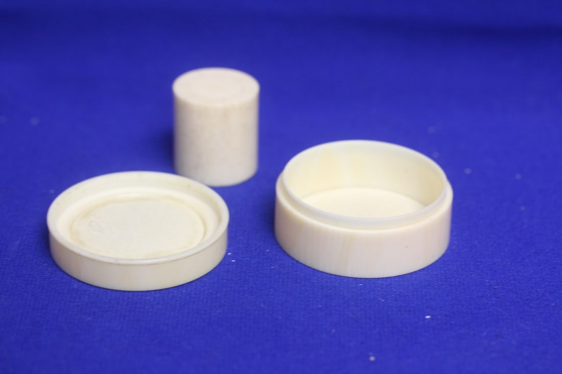 A Well Carved Bone Trinket Box: and possibly a bone stopper or plug or handle - box= 2 inches in diameter