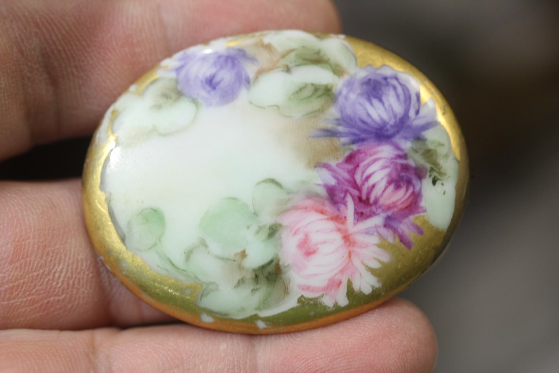 A Small Oval Porcelain Plaque: handpainted - 2" across