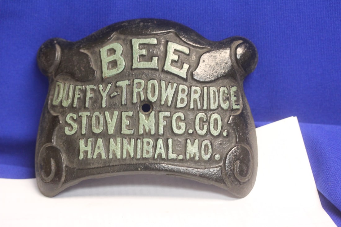 A Cast Iron Plaque: Bee Duffy-Trowbridge Stove Manufactring Co, Hannibal, Mo - 6 1/4" across