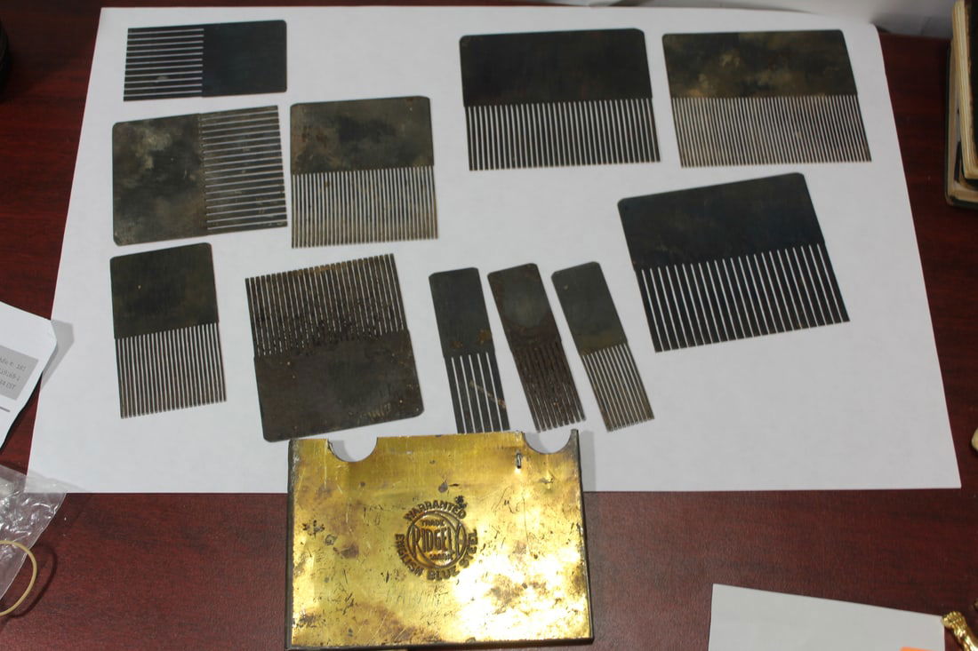 A Vintage English Blue Steel Comb Set: inside a case - total of 11 combs
