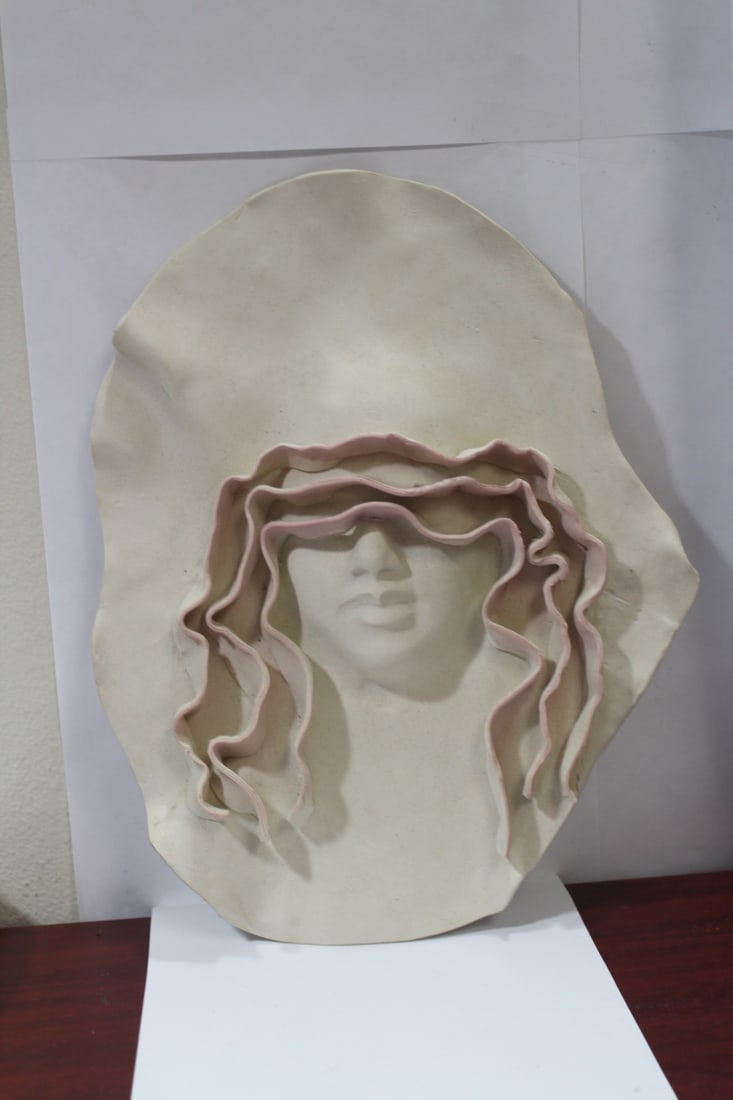 A Modern Ceramic Head Wall Hanger: 15" across