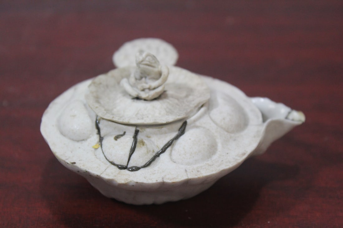 A Ceramic Teapot: please note: chips, restored - 4 1/2" across