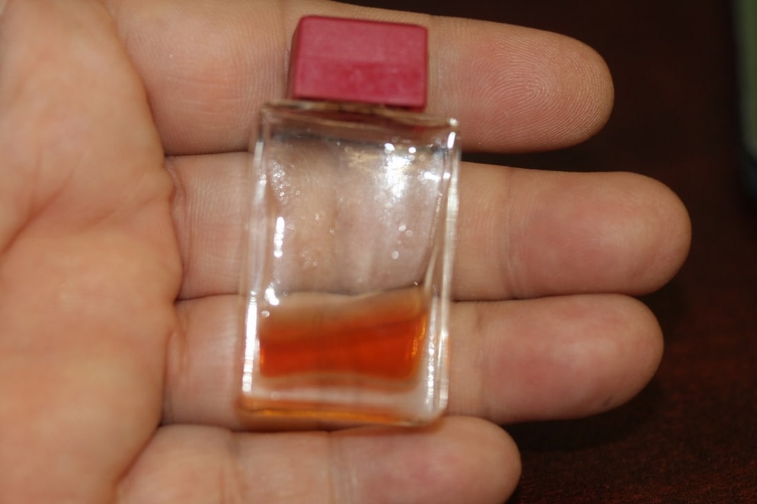 A Small Perfume Bottle: with a little bit of parfume inside - brand is unknown