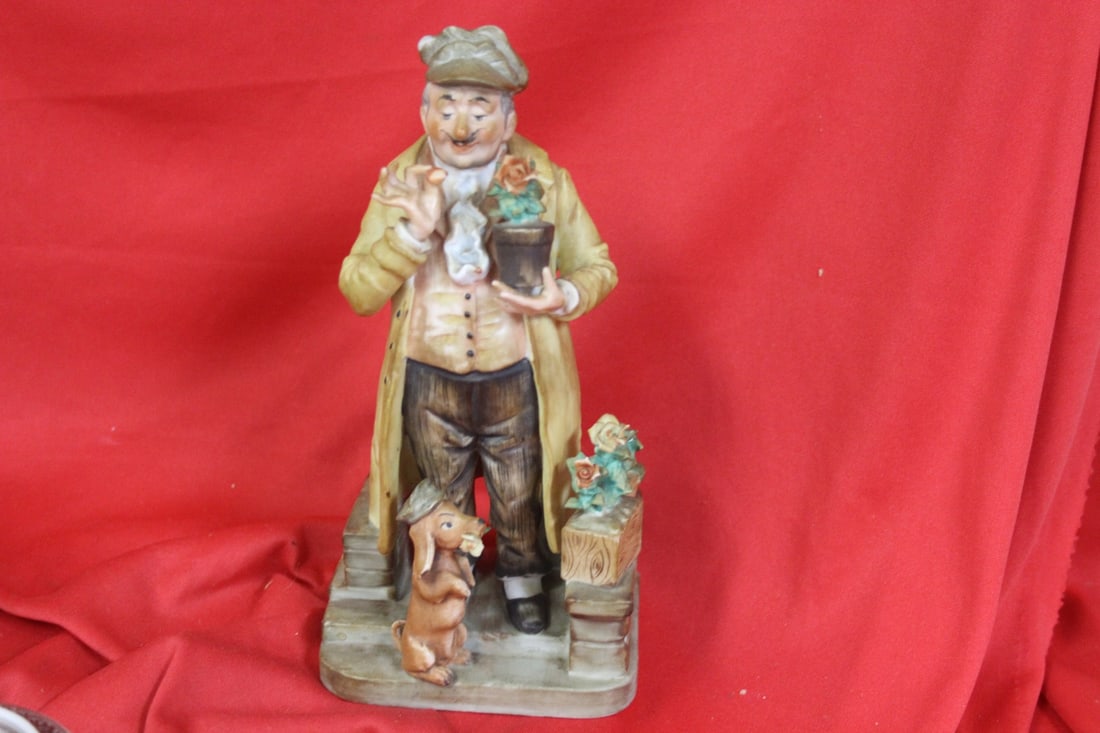 A Well Carved Porcelain Figurine: please note: small chip on the hat - 8 3/8" tall - signed on the bottom