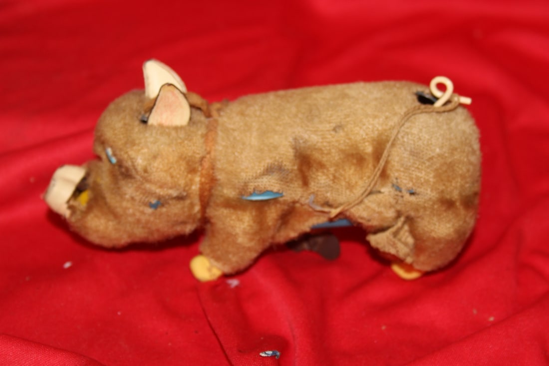 A Handwind Toy: Worn on tin - appears to be working - mechanism is tight - 6 1/4" long