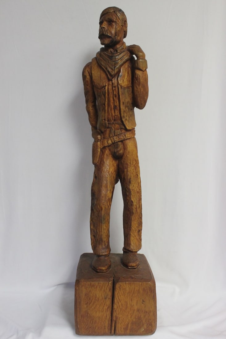 A Wood Statue of a Cowboy: carved from a single piece of wood - signed and dated - looks to be a limited edition of 19/100 - 27" tall