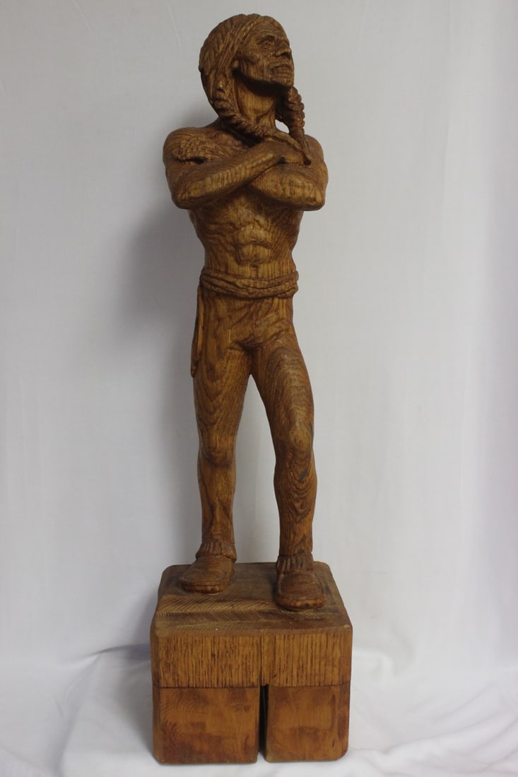 A Wood Statue of a Native American Man: carved from a single piece of wood - signed and dated - 26" tall