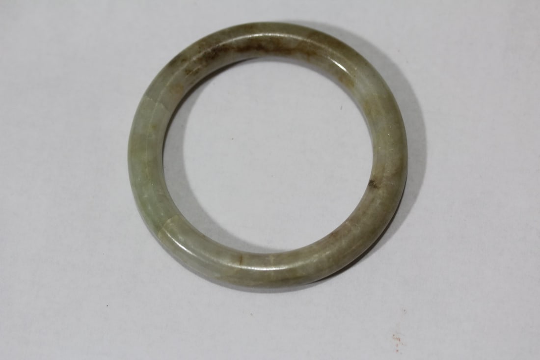 A Nephrite Jade Russett Bangle Bracelet: 1 7/8" inside diameter - small for hand, possibly for child - please note: couple of hairlines