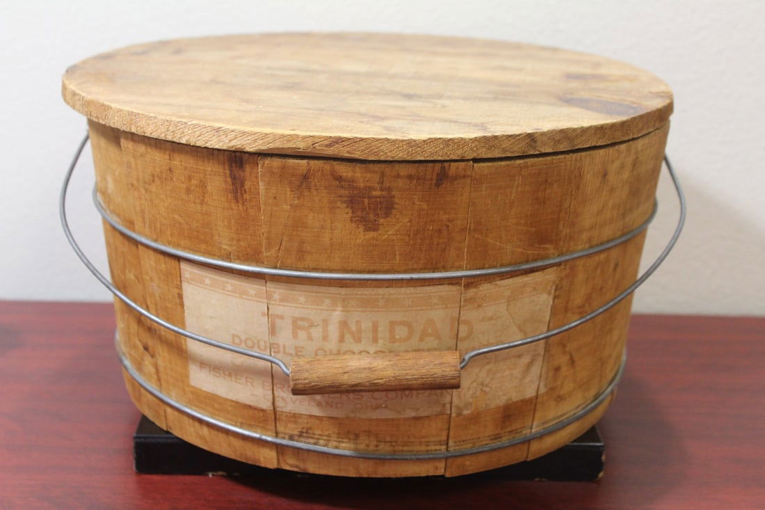 A Wooden Bucket with Handle: 14" in diameter - label says Trinidad chocolate mints - old advertising?