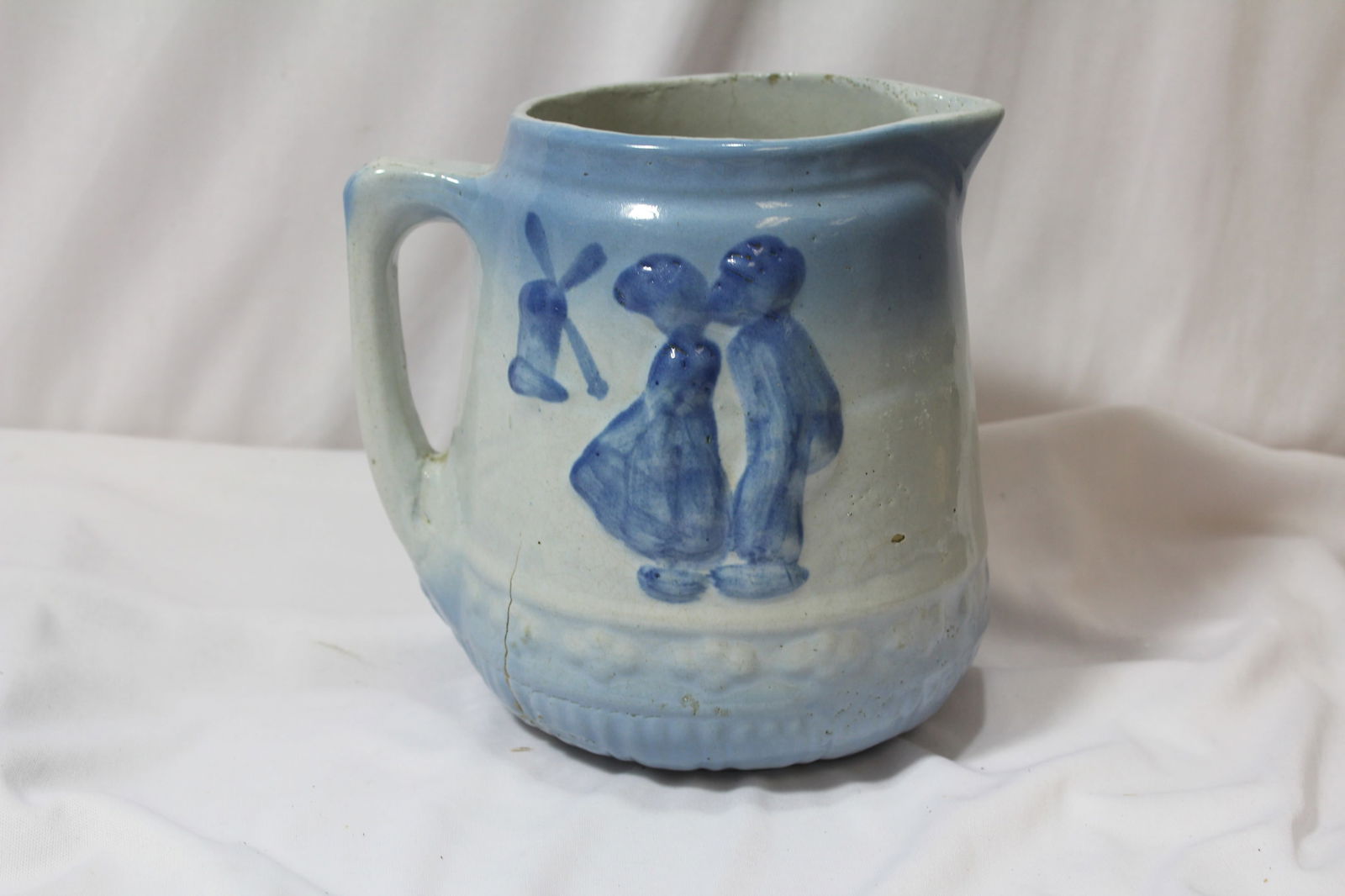 An Antique Stoneware Pitcher: Possibly Dutch - 7" tall - please note: manufacturer's defect