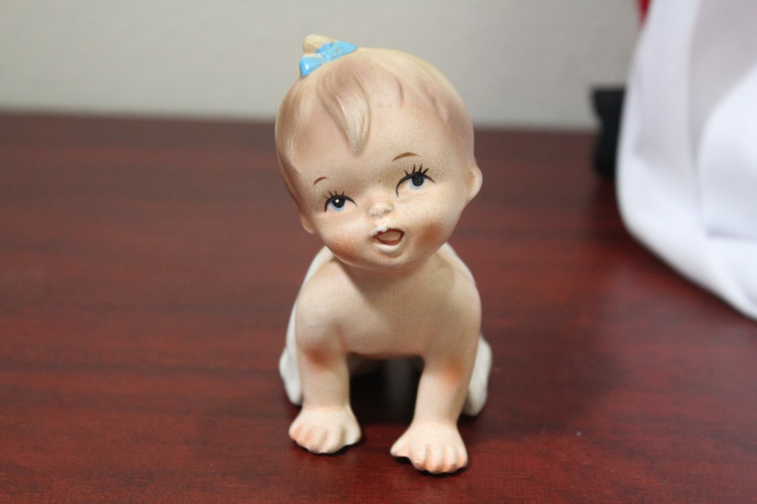 A Ceramic Baby Girl Figurine: 3 3/4" tall