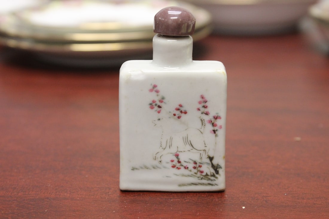 An Antique Chinese Porcelain Snuff Bottle: approximately 3" tall - please note: chips, worn