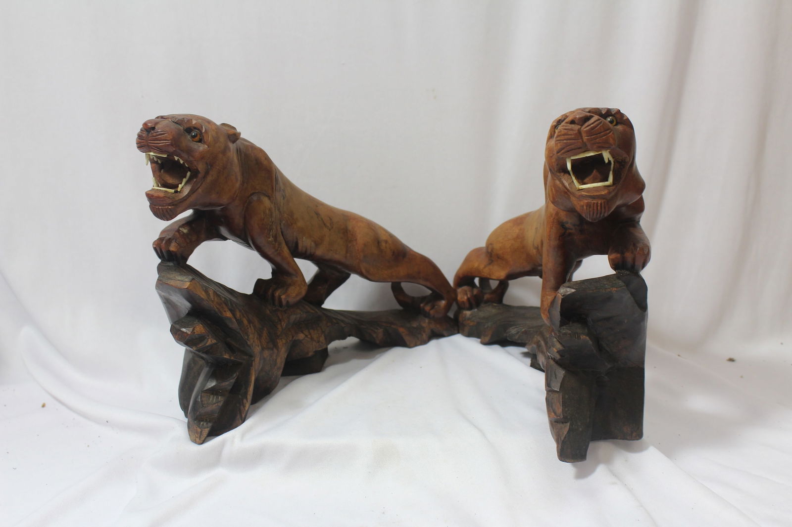 A Pair of Wooden Asian Tigers: please note: one of the tigers is missing teeth - 9 1/2" long