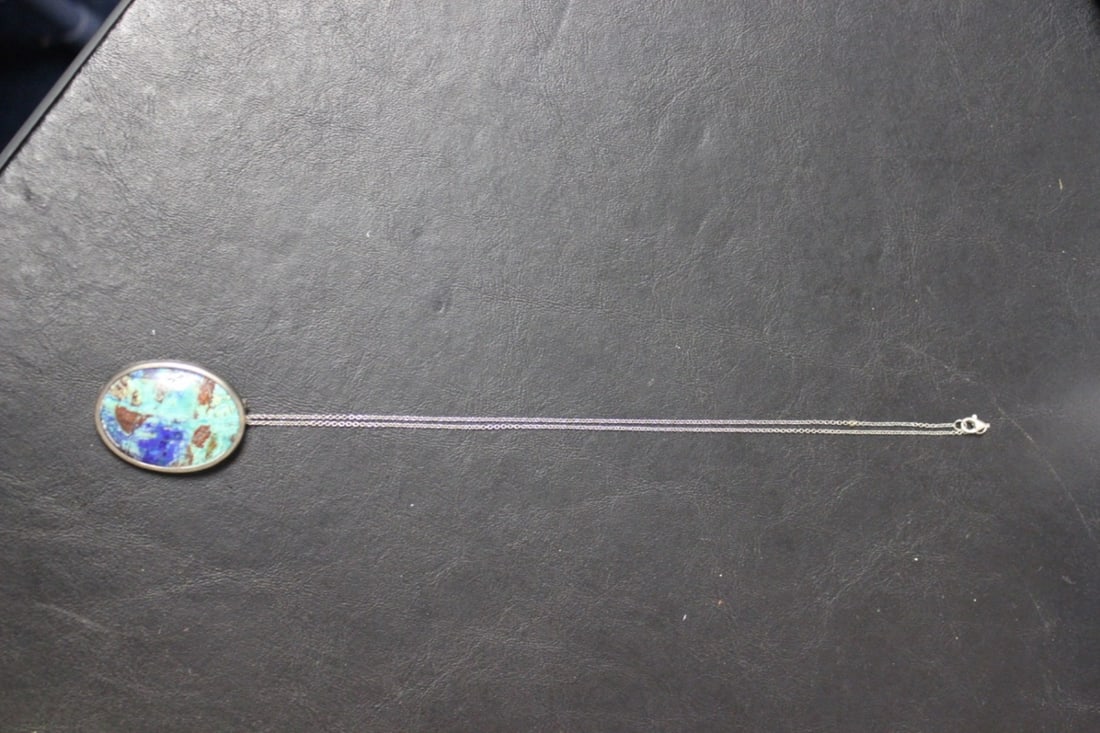 A Sterling and Turquise Pendant with Chain: Pendant can also be worn as a brooch - pendant= 1 3/4" in diameter - chain= 9 inches long