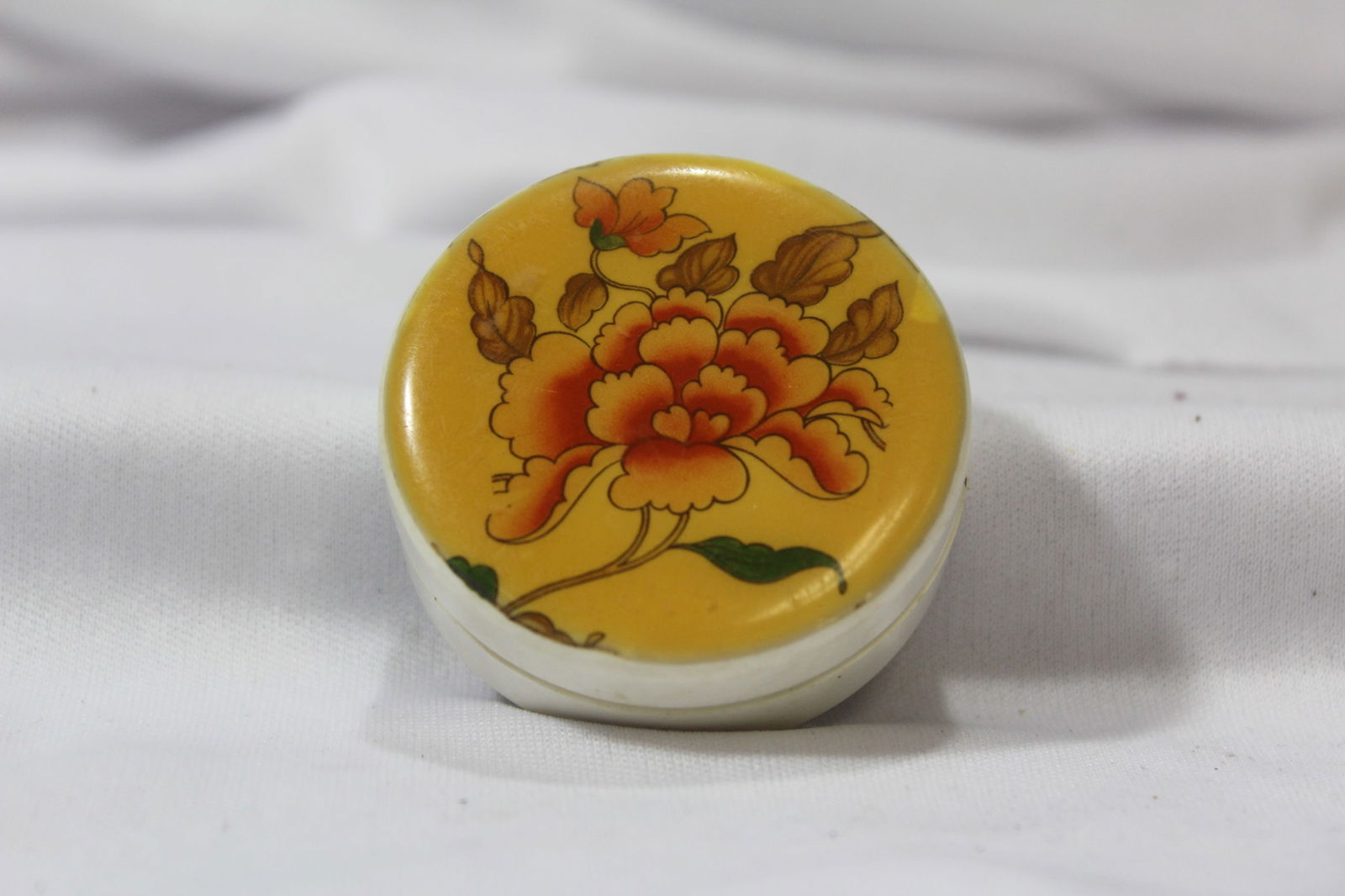 An Old Plastic Trinket Box or Powder Box: 2" in diameter