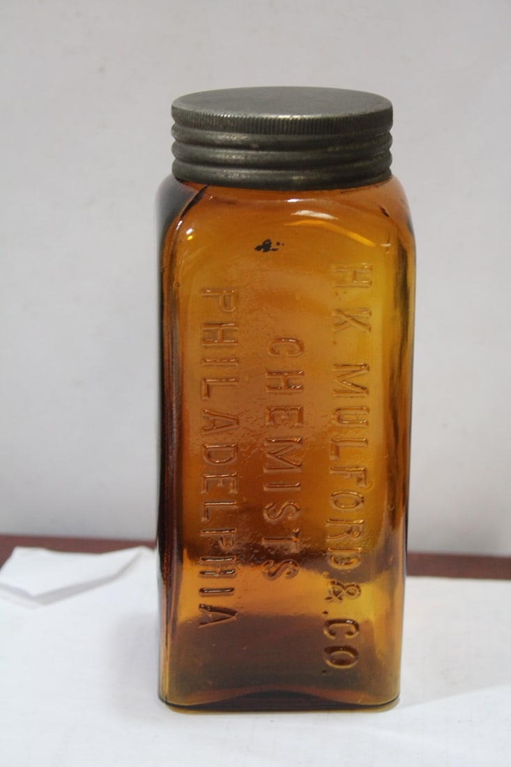 A Mulford and Company Chemist Bottle: marked "J" on the bottom - amber color - 7" tall